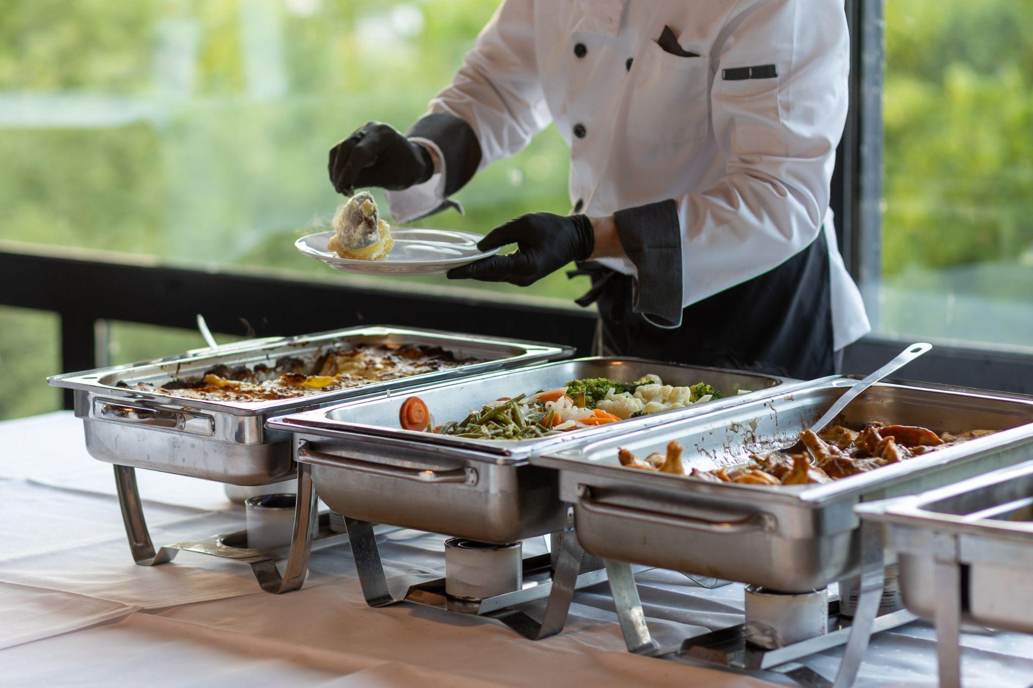 Vegetables, potatoes, and meat offered at a catering event
