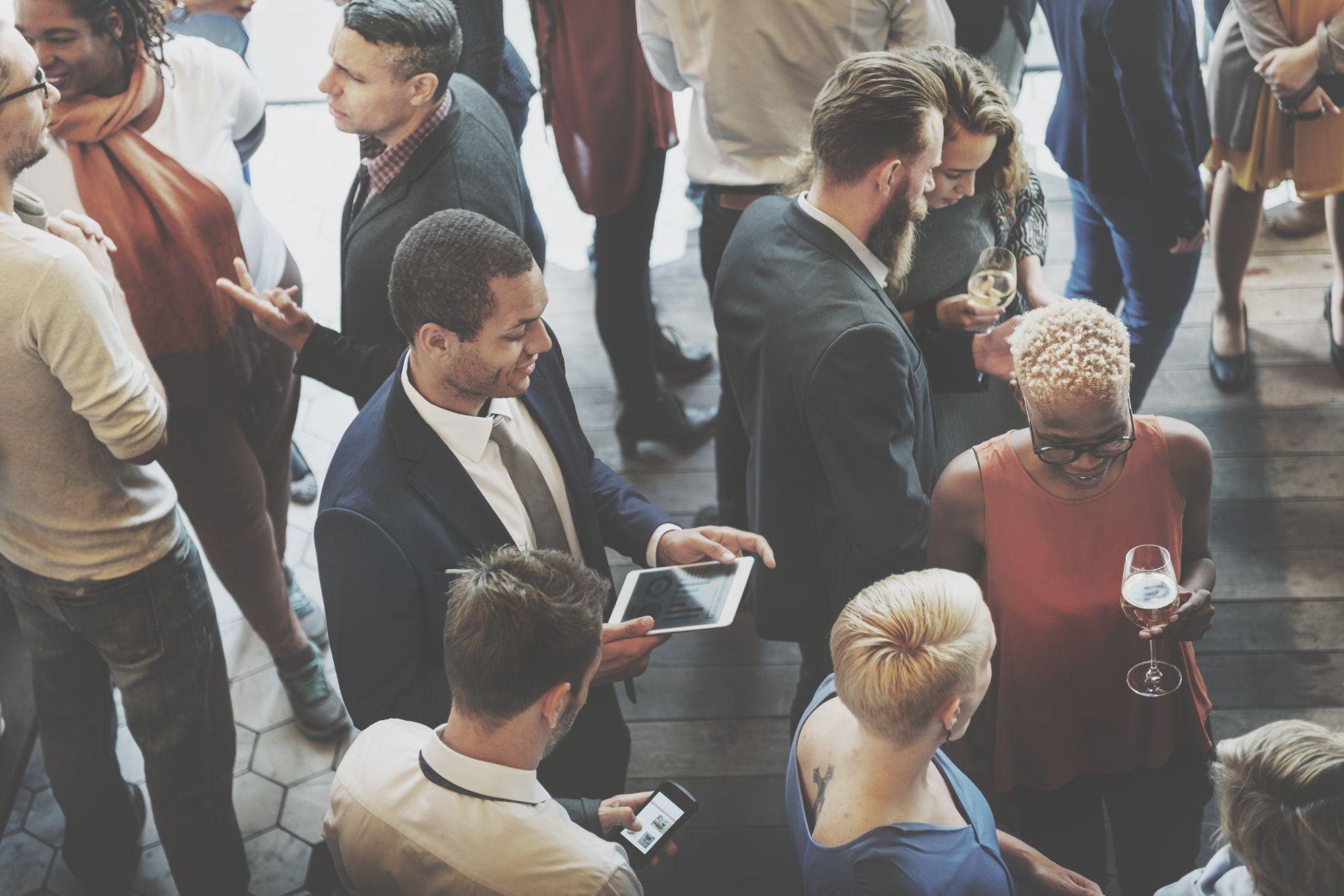 Office employees socializing and networking during a celebration.