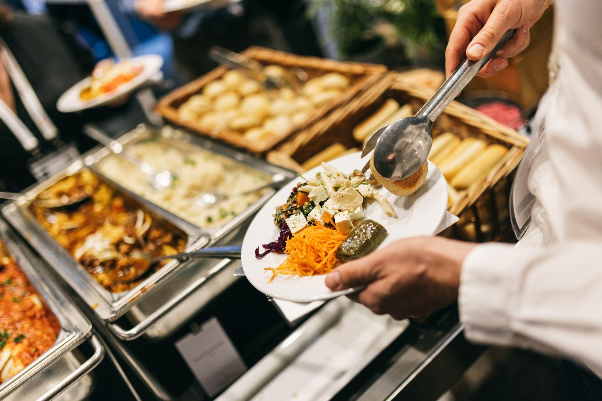 Buffet setup at a Seattle corporate event with fresh entrées and sides, illustrating seamless catering coordination in meeting spaces with a view.